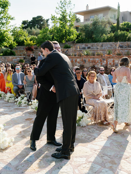 Groom standing with a family member before the wedding ceremony begins