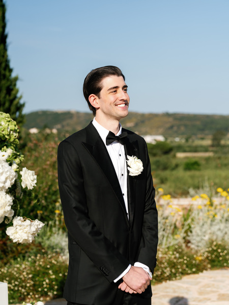 Portrait of the groom in a classic black tuxedo before the ceremony