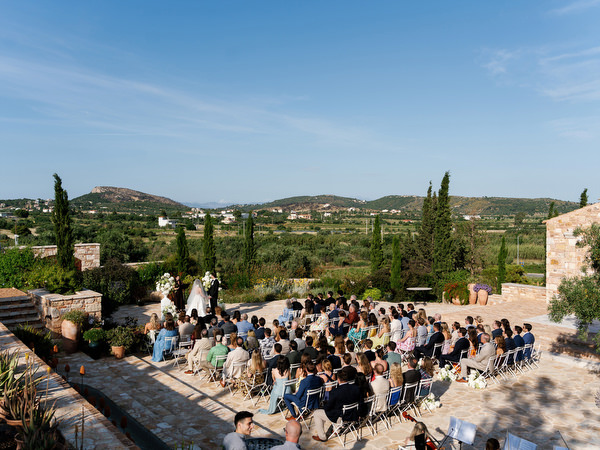 Wide elevated view of the outdoor wedding ceremony at Pyrgos Petreza