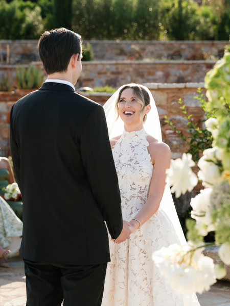 Bride and groom facing each other at the altar during the outdoor ceremony