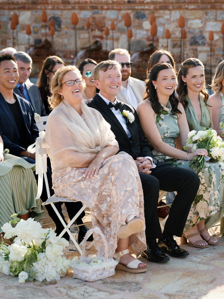 Wedding guests watching Kristen and Steven exchange vows at Pyrgos Petreza