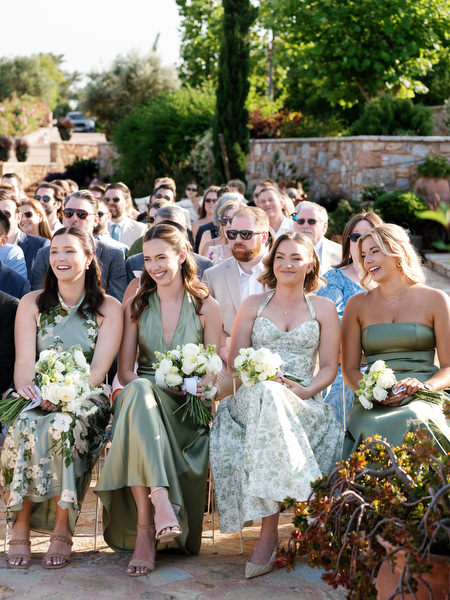 Guests reacting warmly during the couple’s destination wedding ceremony near Athens