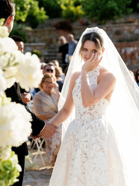 Bride smiling behind her veil during the romantic ceremony at Pyrgos Petreza