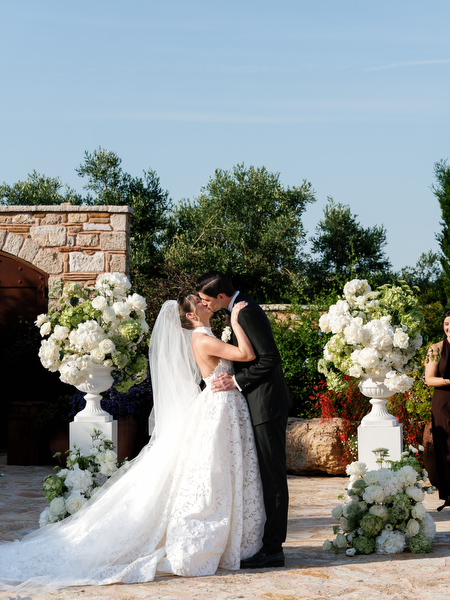 Bride and groom sharing a kiss at the altar during their Athens destination wedding