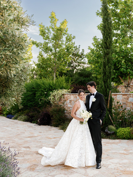 Newlyweds walking through the gardens during romantic portraits at Pyrgos Petreza