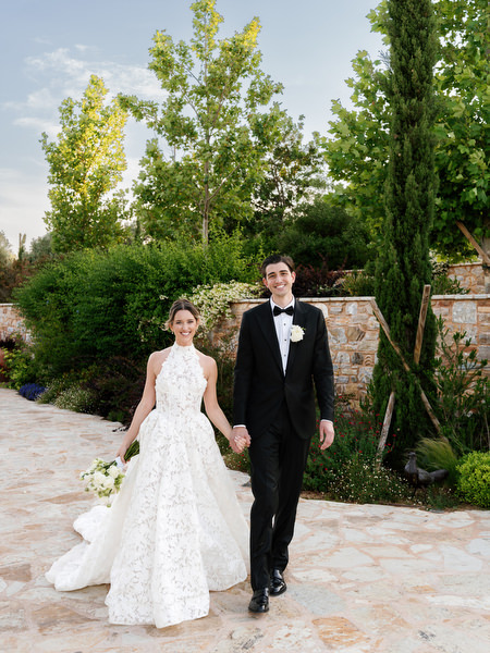 Groom standing beside the bride during elegant garden wedding portraits