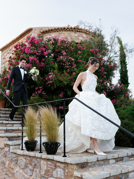 Bride walking along the stone steps in her lace gown during romantic portraits