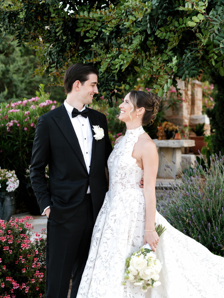 Bride and groom sharing a quiet moment surrounded by Mediterranean greenery