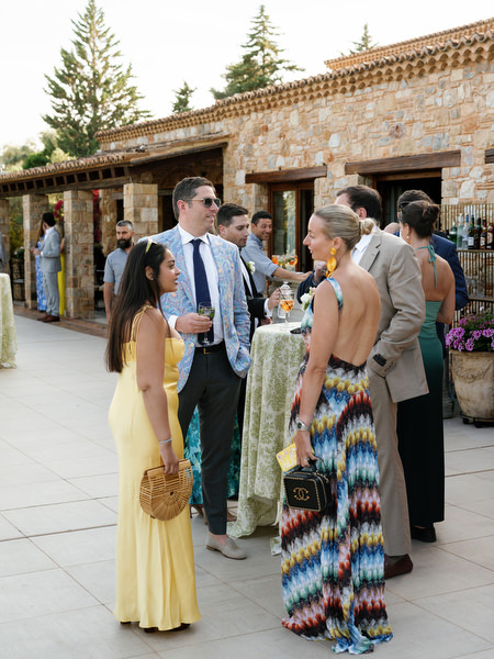 Wedding guests walking through the stone courtyard during cocktail hour