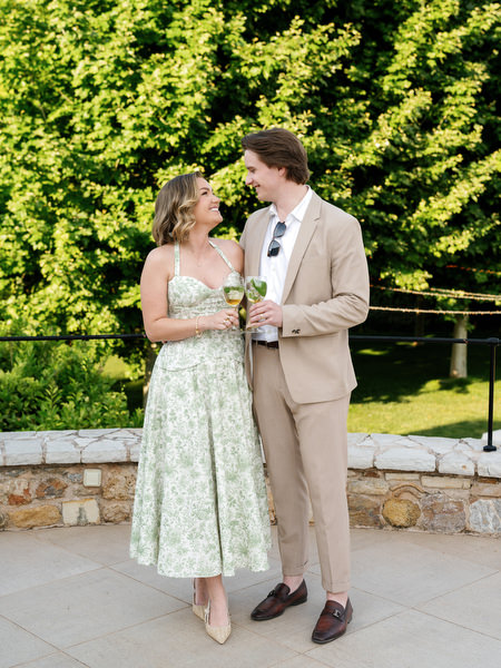 Wedding guests posing together against lush green foliage at Pyrgos Petreza