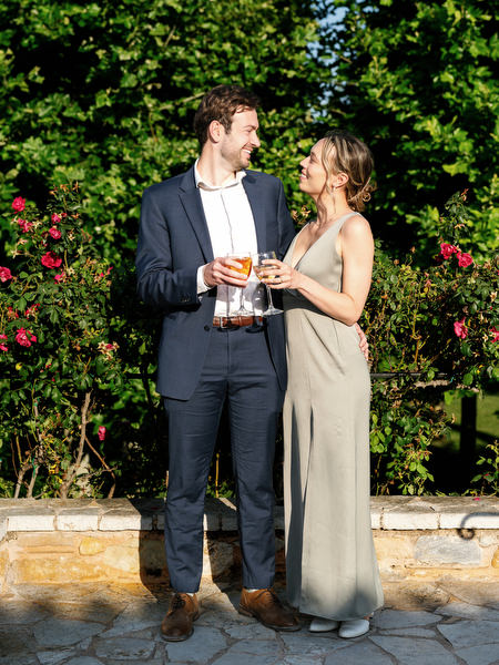 Wedding guests chatting together during cocktail hour in the Mediterranean gardens
