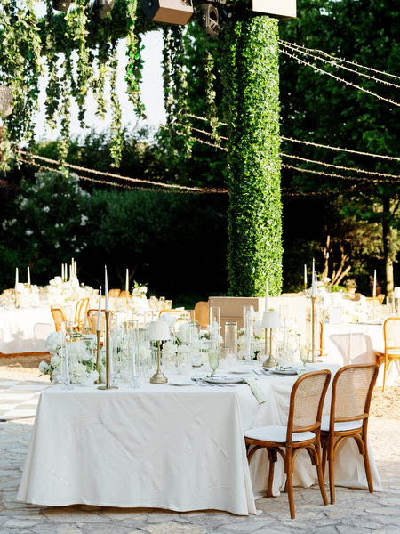 Long reception table beneath cascading greenery at the Pyrgos Petreza wedding
