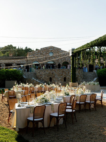 Wide view of the elegant al fresco wedding reception near the stone venue