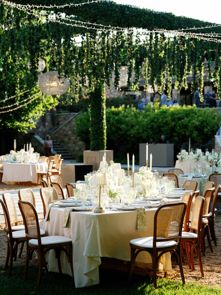 Candlelit reception tables beneath hanging greenery at Pyrgos Petreza