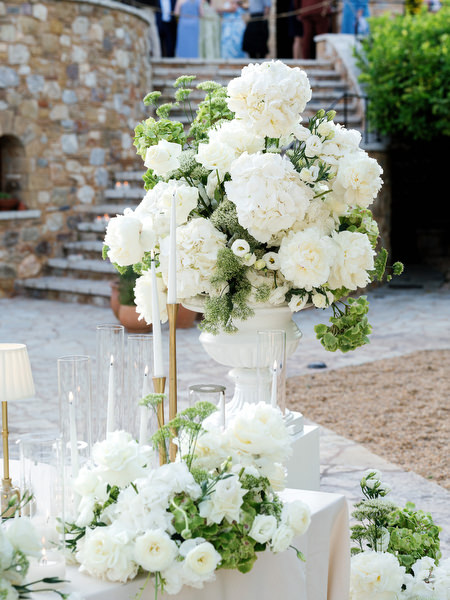 White floral centerpieces decorating the elegant outdoor wedding reception