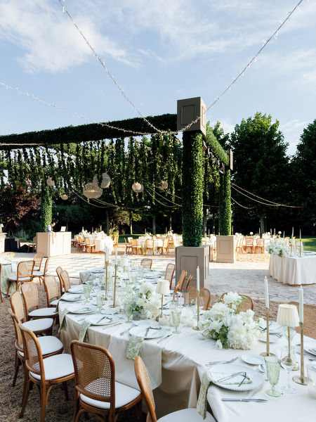Long al fresco dinner table with candles and floral arrangements at Pyrgos Petreza