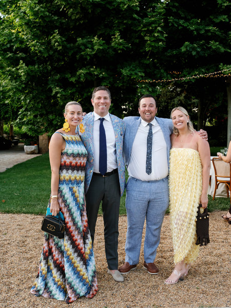 Wedding guests posing together during cocktail hour in the gardens near Athens