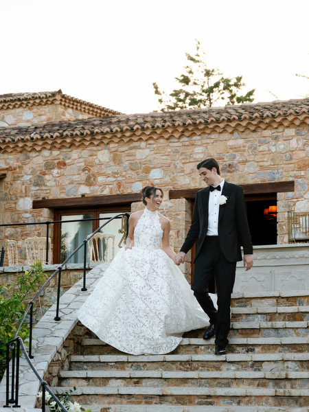 Bride and groom walking down the stone steps together at Pyrgos Petreza