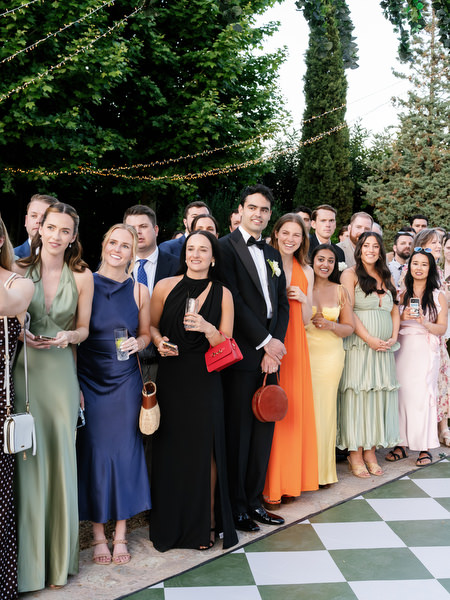 Wedding guests gathered around the patterned dance floor before the reception begins