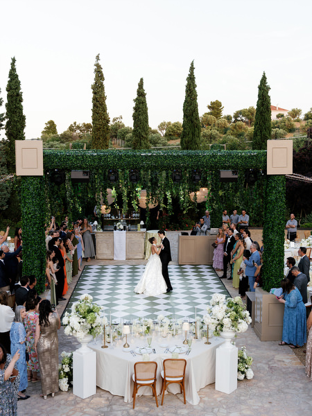 Wide view of the patterned dance floor and sweetheart table at Pyrgos Petreza