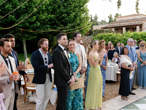 Wedding guests smiling and watching the couple’s first dance at Pyrgos Petreza