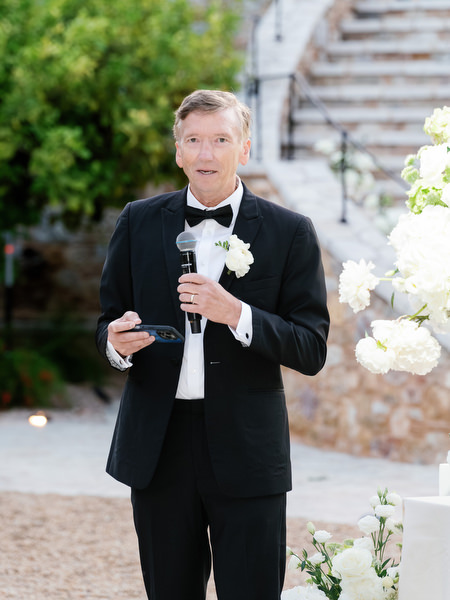 Groom giving a speech during the elegant outdoor wedding reception