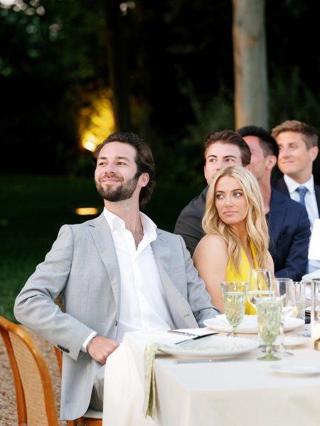 Wedding guests reacting during speeches at the Pyrgos Petreza reception