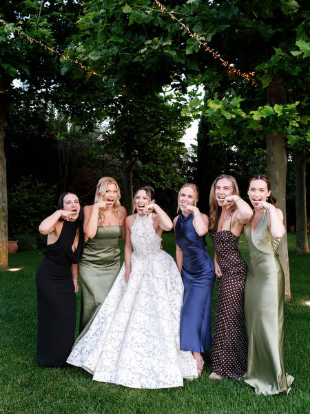 Bride posing with bridesmaids during the evening reception near Athens