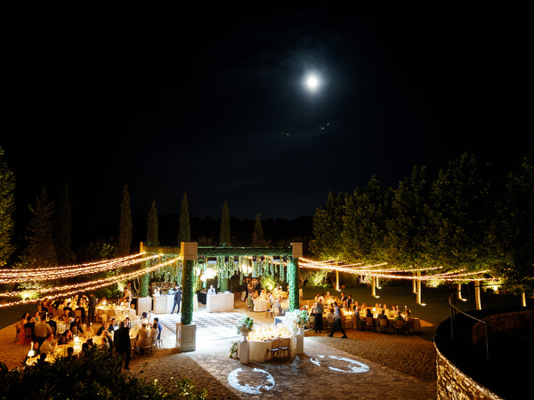 Night view of the illuminated Pyrgos Petreza reception beneath the moon