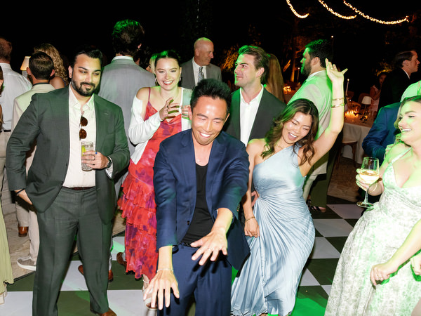 Group of guests dancing together during the energetic Pyrgos Petreza wedding party
