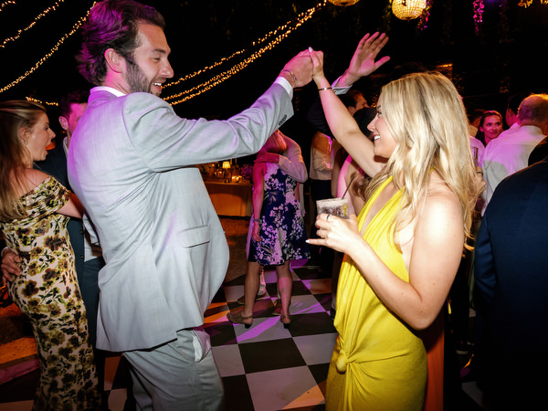 Wedding guests dancing and cheering during the lively evening celebration