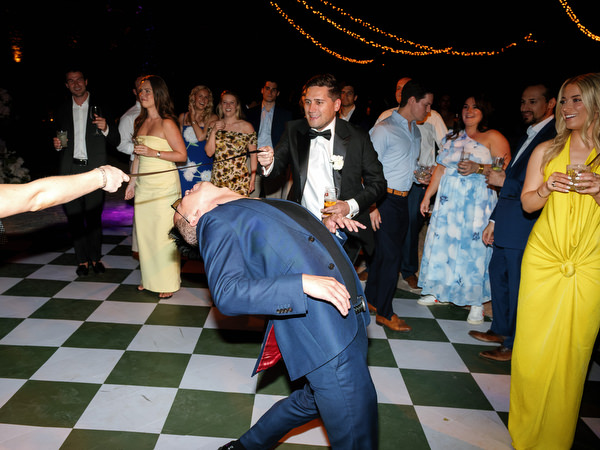 Wedding guest dancing energetically on the patterned dance floor