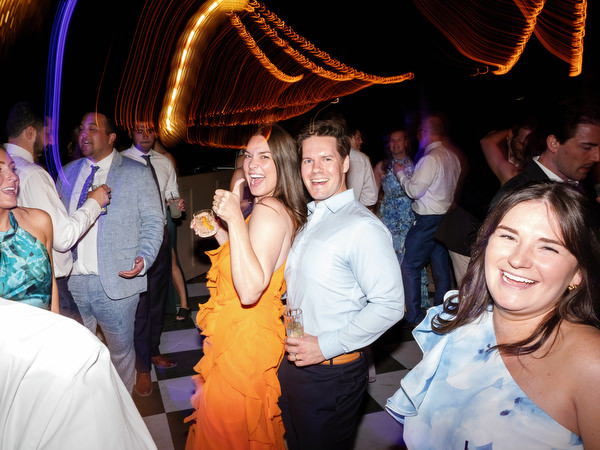 Guests celebrating with raised hands during the lively destination wedding party
