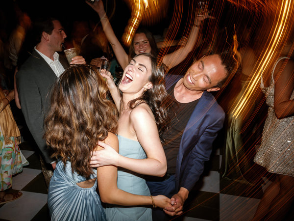 Wedding guests dancing together during the energetic late-night reception