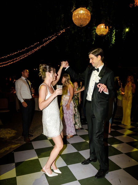 Bride and groom dancing together on the patterned floor during the wedding party