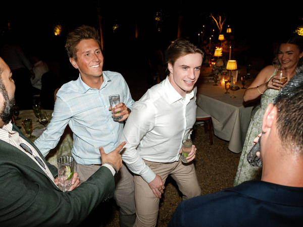 Wedding guests laughing and dancing together during the late-night reception