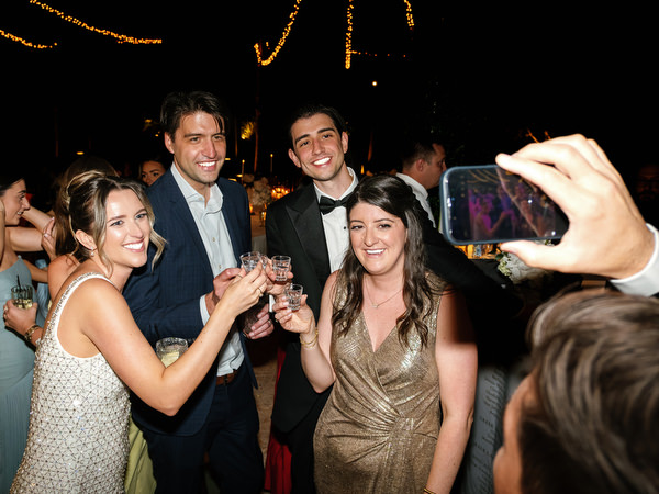 Wedding guests smiling and dancing during the energetic Athens wedding party