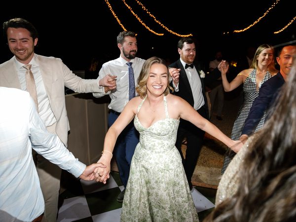 Wedding guest dancing with friends during the late-night party near Athens