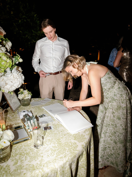 Wedding guest signing a guest book during the Pyrgos Petreza reception