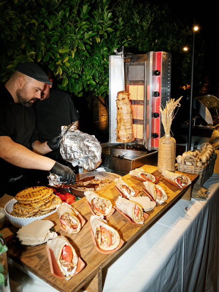 Late-night food station serving guests during the wedding reception